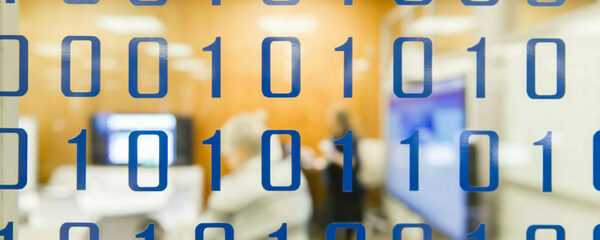 Binary code on a clear glass wall looking into a meeting room.
