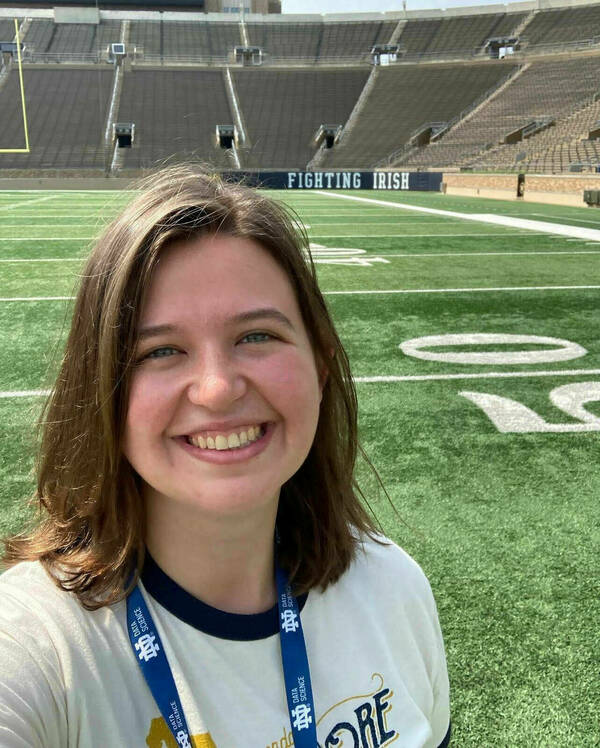 Amanda Cameron takes a selfie on the field of the stadium.